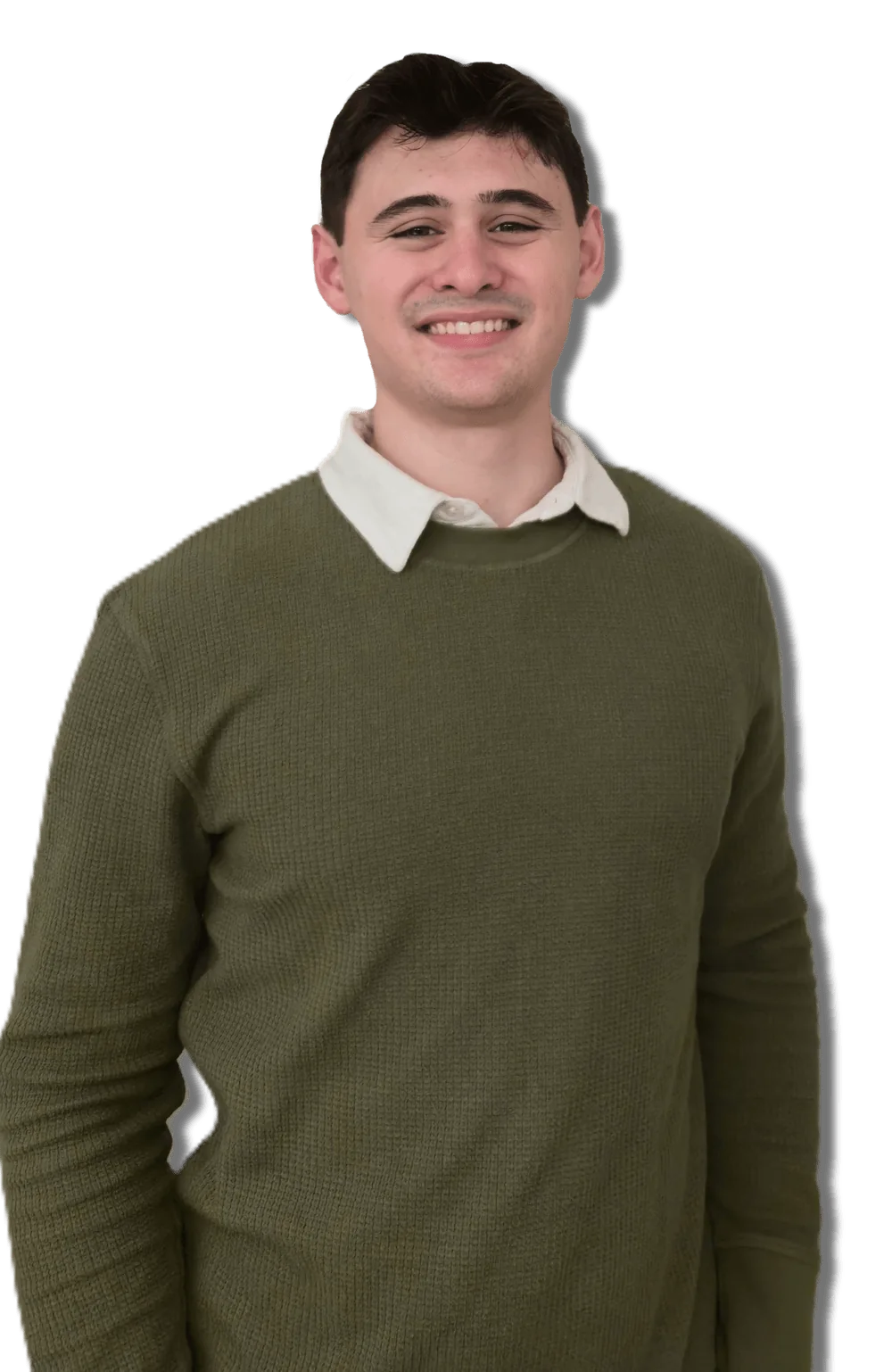 Travis Heavener smiling in a white polo and green sweater